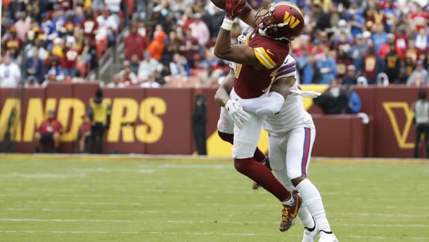 Sep 24, 2023; Landover, Maryland, USA; Washington Commanders cornerback Kendall Fuller (29) intercepts a pass intended for Buffalo Bills wide receiver Gabe Davis (13) during the third quarter at FedExField. Mandatory Credit: Geoff Burke-USA TODAY Sports  